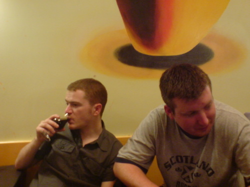 The lads beneath a big yellow thing on the wall